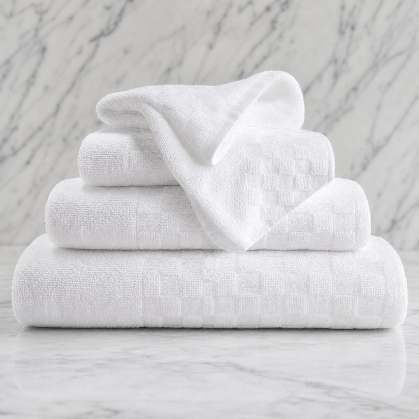 Textured white checkered bath towel on a marble counter